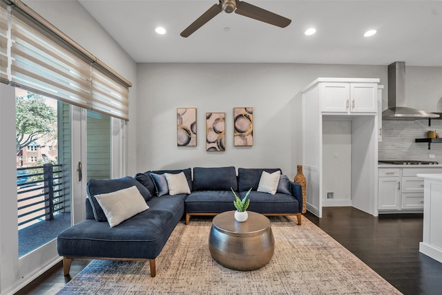 living room featuring dark wood-type flooring and ceiling fan