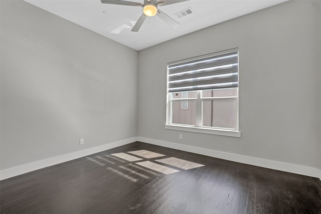 spare room with dark hardwood / wood-style floors and ceiling fan