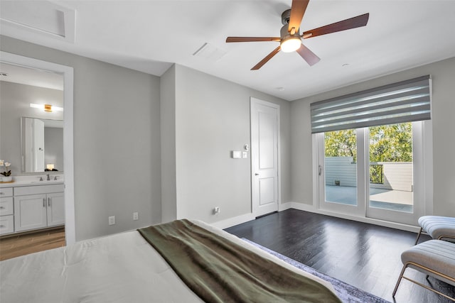 bedroom with access to outside, sink, ensuite bath, ceiling fan, and dark hardwood / wood-style floors