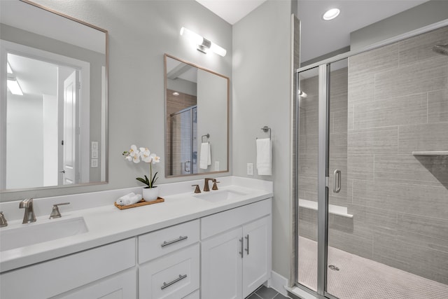 bathroom featuring vanity and a shower with shower door