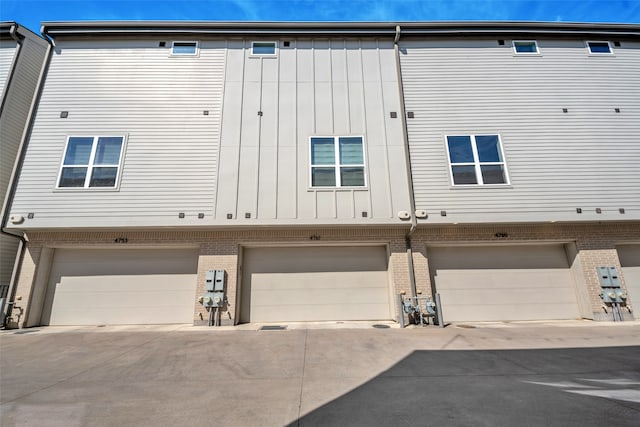 rear view of property with a garage