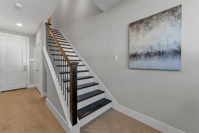 stairway with concrete floors