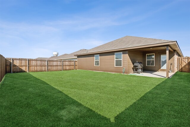 back of house with a yard and a patio area