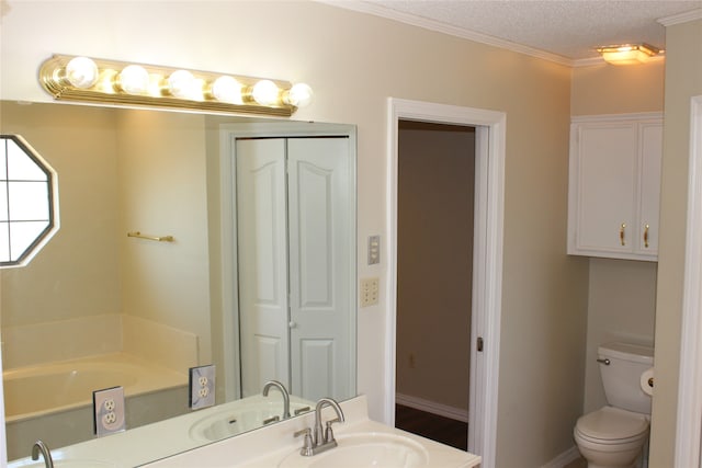 bathroom featuring a textured ceiling, sink, toilet, and ornamental molding