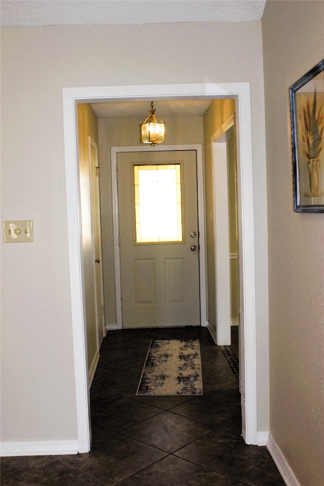 entryway featuring dark tile patterned flooring