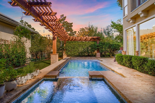 pool at dusk featuring a patio, a pool with connected hot tub, and a pergola