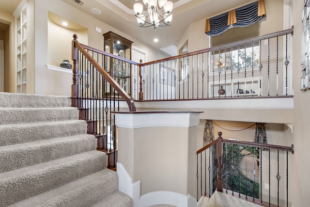 staircase featuring recessed lighting, visible vents, and an inviting chandelier