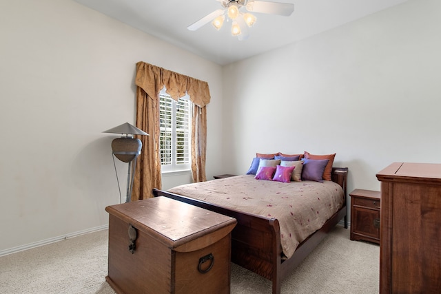 bedroom featuring ceiling fan, baseboards, and light colored carpet