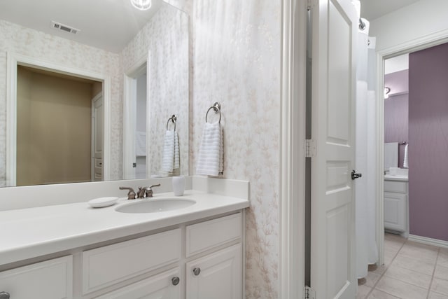 bathroom featuring wallpapered walls, tile patterned flooring, visible vents, and vanity