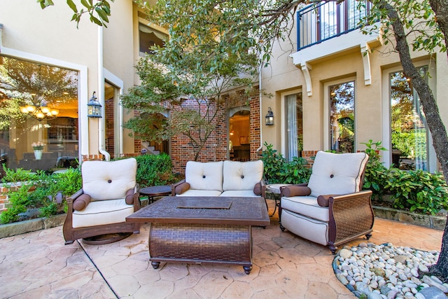 view of patio featuring a balcony and an outdoor living space