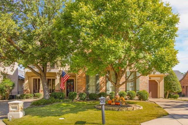 obstructed view of property featuring a garage, driveway, and a front yard