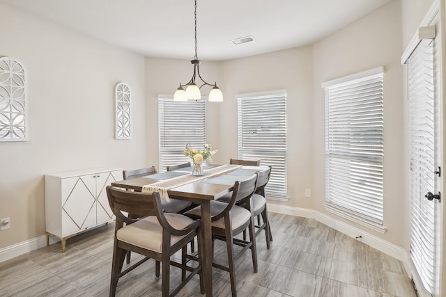 dining area featuring a notable chandelier and a healthy amount of sunlight