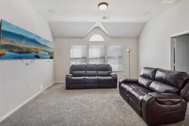 carpeted living room featuring lofted ceiling