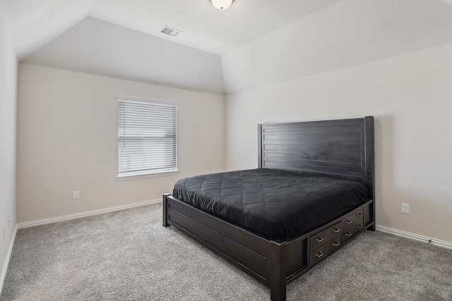 bedroom with light colored carpet and vaulted ceiling