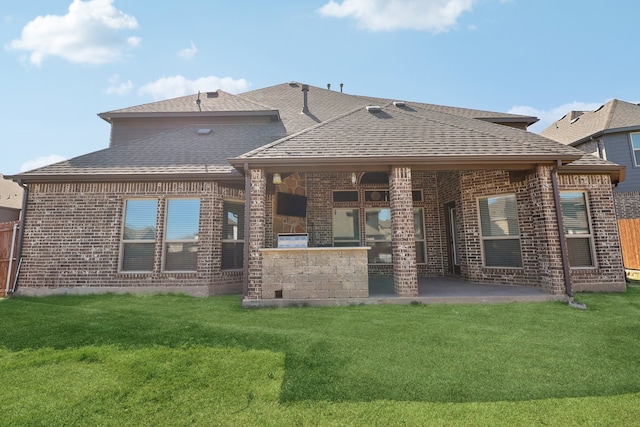 rear view of house with a yard and a patio