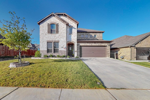 view of front of property with a garage and a front yard