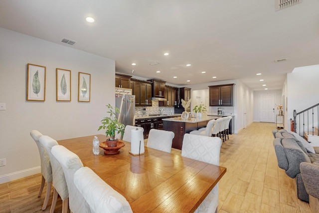 dining space featuring light hardwood / wood-style floors