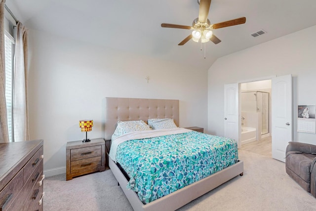 bedroom featuring carpet, ceiling fan, connected bathroom, and vaulted ceiling