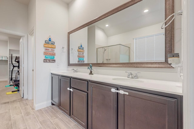 bathroom with vanity, an enclosed shower, and hardwood / wood-style flooring