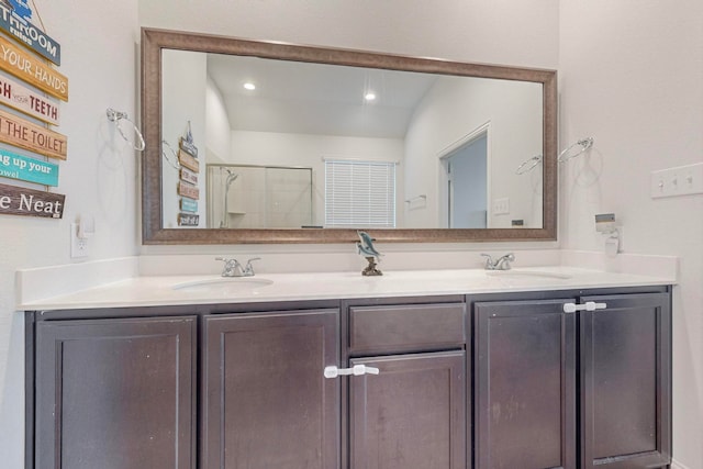 bathroom featuring vanity, lofted ceiling, and walk in shower