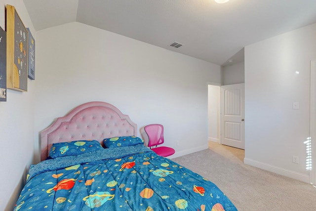 bedroom featuring light colored carpet and lofted ceiling