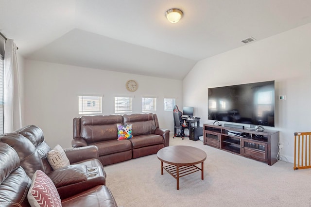 carpeted living room with lofted ceiling