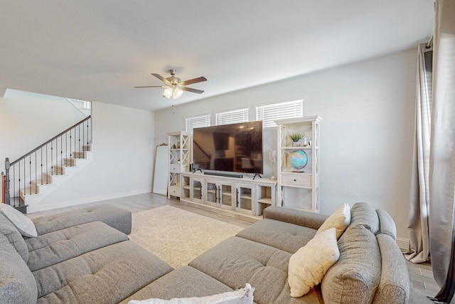 living room featuring ceiling fan and light wood-type flooring