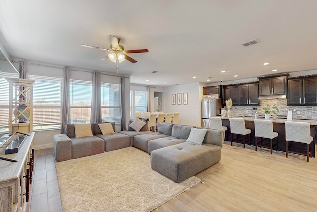 living room featuring ceiling fan and light wood-type flooring