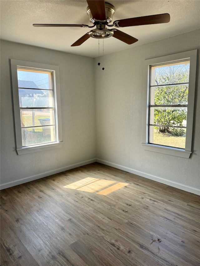 spare room featuring hardwood / wood-style floors and ceiling fan