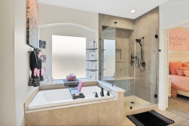 bathroom with tile patterned flooring, a healthy amount of sunlight, and plus walk in shower