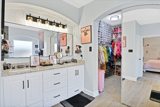 bathroom with hardwood / wood-style floors and vanity