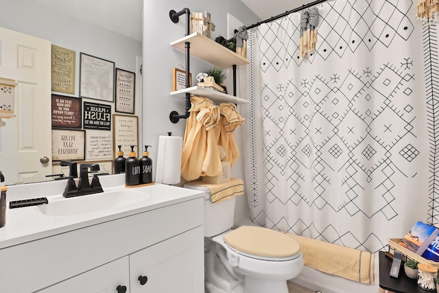 bathroom featuring curtained shower, vanity, and toilet