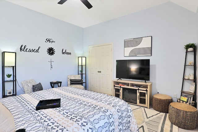 carpeted bedroom with ceiling fan and lofted ceiling