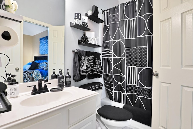 full bathroom featuring shower / tub combo, vanity, and toilet