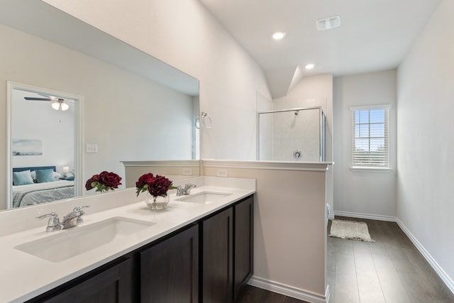 bathroom with vanity, hardwood / wood-style floors, a shower with shower door, and ceiling fan