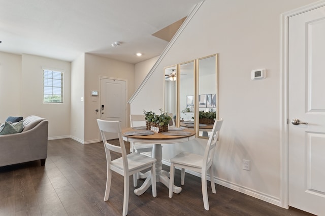 dining space with ceiling fan and dark hardwood / wood-style floors