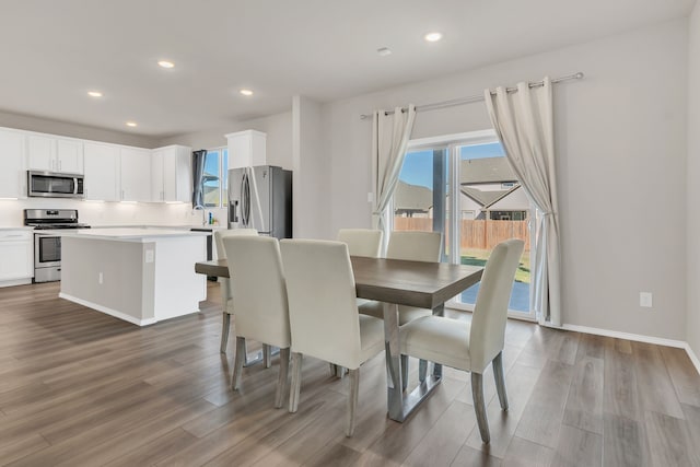 dining room with hardwood / wood-style flooring