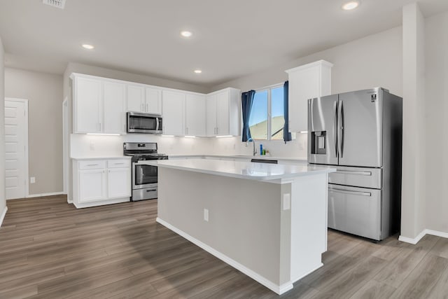 kitchen featuring appliances with stainless steel finishes, white cabinetry, and a kitchen island