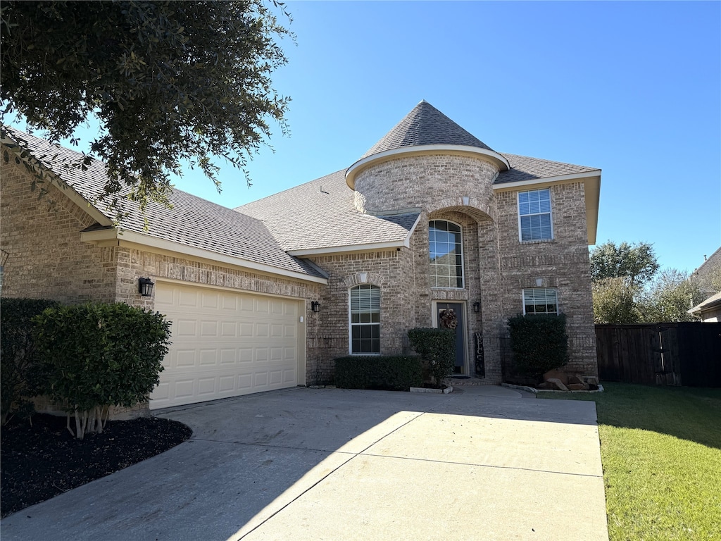 view of front of house featuring a garage and a front lawn