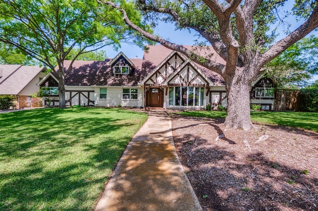 english style home with a front yard