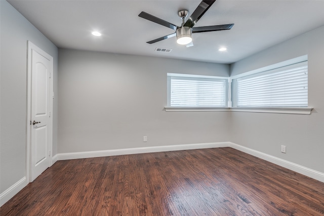 spare room featuring dark hardwood / wood-style floors and ceiling fan