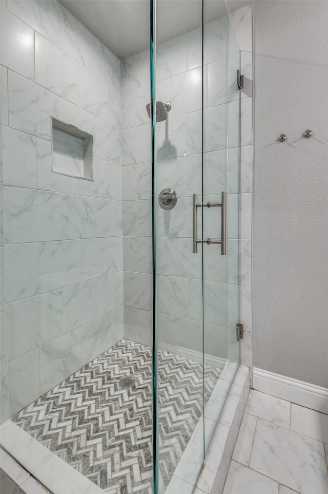 bathroom with a shower with shower door