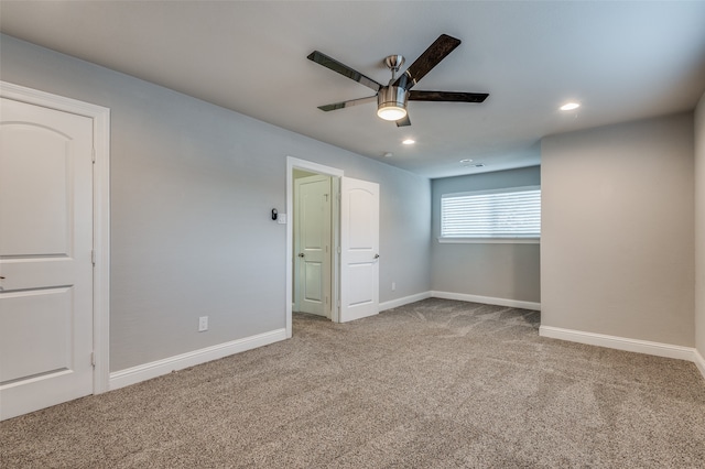 unfurnished bedroom featuring light colored carpet and ceiling fan