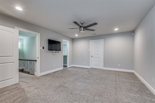 spare room with carpet and ceiling fan