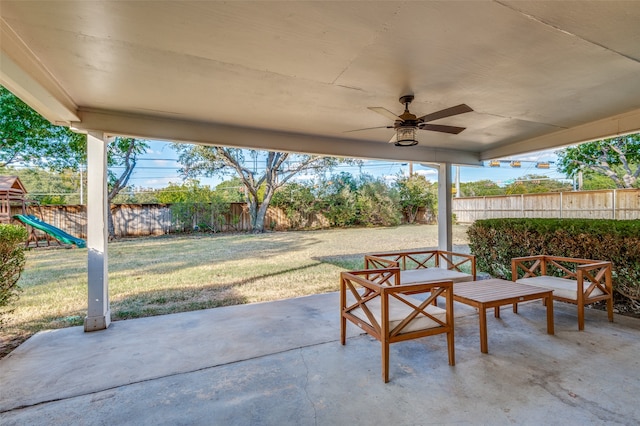 view of patio with ceiling fan and a playground