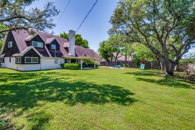 view of yard featuring a patio and a playground