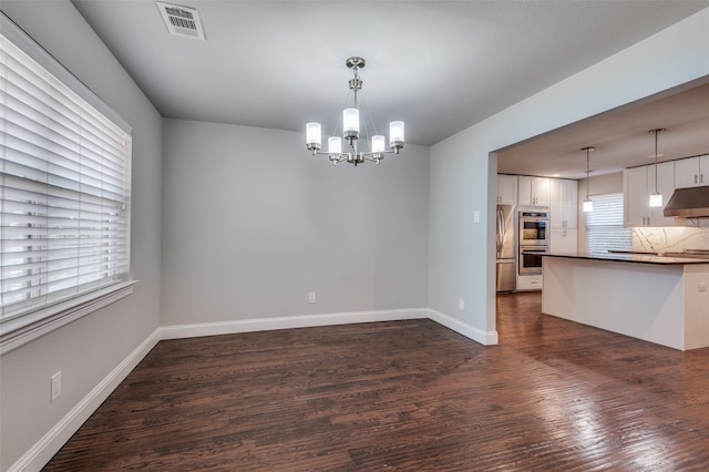 interior space featuring a notable chandelier and dark hardwood / wood-style floors