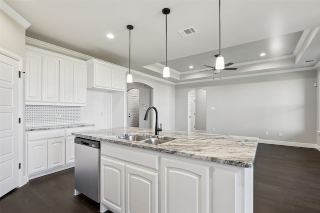 kitchen featuring dishwasher, white cabinets, a center island with sink, a raised ceiling, and sink