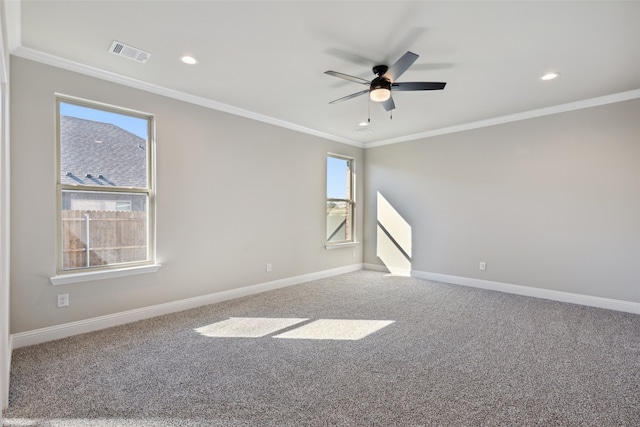 carpeted empty room with crown molding, plenty of natural light, and ceiling fan