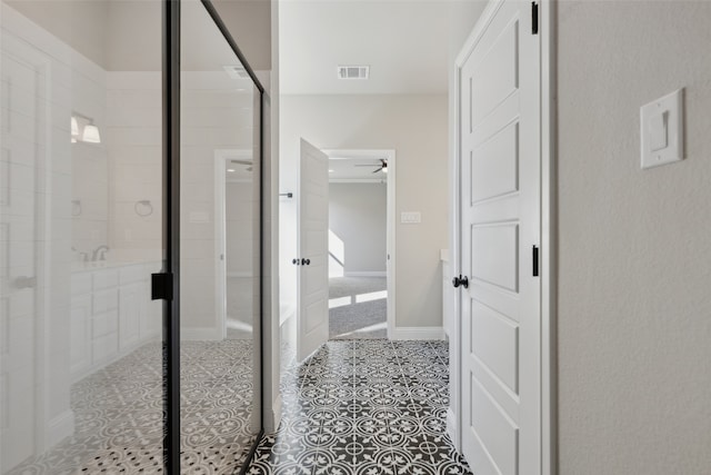 bathroom with ceiling fan and an enclosed shower